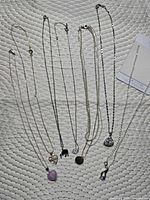 Group shot showing all eight necklaces laid out