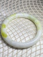 Jade bangle on fabric background showing overall appearance and coloration