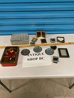 Group shot of entire lot on table with measuring stick for scale