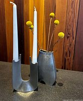 Candlestick and bud vase standing side by side