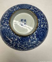 Overall underside view showing lotus pattern, metal foot rim and base mark.