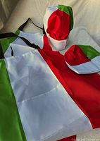 Set of two aprons and two chef hats laid out showing full tricolor design