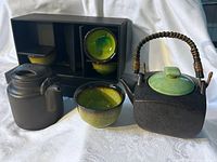 All items: two teapots, four cups, storage box