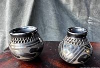 Two blackware jars showing overall form and patterns