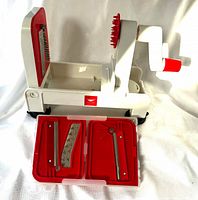 Spiralizer assembled with blade storage box open showing two blades and tool