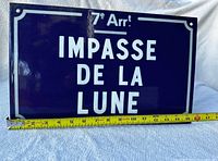 Front view of Paris street sign with tape measure for scale