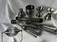 Full view of all stainless steel bar and kitchen tools on white background