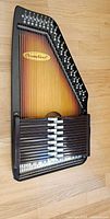 Front view of ChromAharp autoharp showing strings, chord bars and logo
