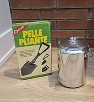 Percolator beside boxed Coghlan's shovel showing both items