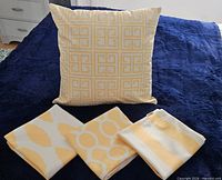 Pillow covers displayed folded with one filled example