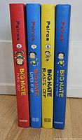 Spine view of four hardcover titles