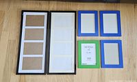 All six frames laid out: two black triple 4×6, four IKEA 5×7 (three blue, one green)