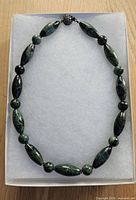 Full view of jasper necklace on display pad