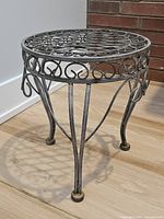 angled view of full metal plant stand showing design and legs