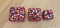 Front view of all three mosaic beaded boxes showing patterns
