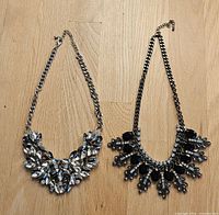 Both necklaces laid flat showing overall design and chain style