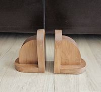 Front view of both wood bookends showing shape and wear
