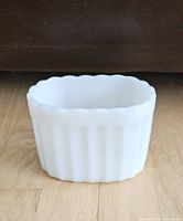 Front view of white milk glass oval planter