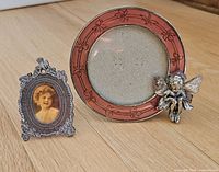 Both miniature frames standing on wood surface