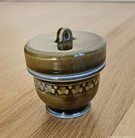 Egg coddler front view with lid on showing glaze and shamrock band