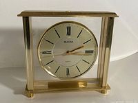 Front view of Bulova brass quartz clock showing overall design