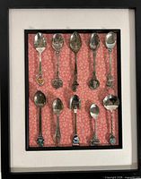 Full view of framed souvenir spoon collection