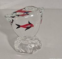 Front view of clear glass fish paperweight showing overall form and fish motif