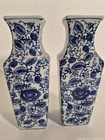 Front view of both blue and white floral ceramic vases