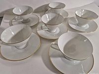 All six teacup and saucer pairs displayed