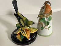 Both ceramic bird figurines together