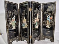 Full view of four-panel black lacquer screen standing