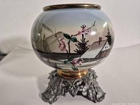 Full view of vase on metal stand showing painted scene and form