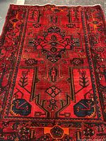 Full view of Persian wool rug showing overall pattern and borders