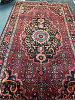 Full view of Persian wool rug showing overall design and size