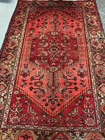 Full view of Persian wool rug showing overall design and colors