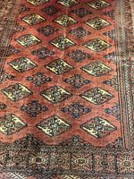 Full view of Bokhara Persian rug showing pattern and colors