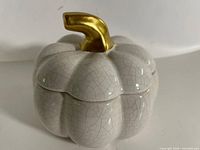 Closed pumpkin pot showing crackle glaze and gold stem