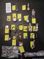 All 19 watches laid out with notes and bag of straps