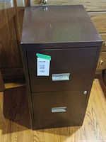 Full view of brown two-drawer metal filing cabinet