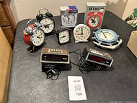 Group shot showing all seven analog clocks and two digital clock radios
