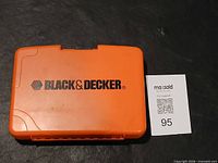 Closed orange Black & Decker branded plastic case