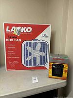 Sealed Lasko box fan beside sealed Super Furnace ceramic heater box