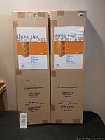 Front view of two sealed boxes displaying product labels and dimensions