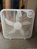 Front view of white box fan standing on floor