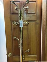 Full view of brass coat rack against door