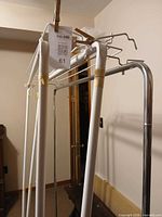 Close view of chrome rack top with bundled white uprights and hangers