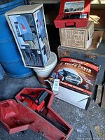 Group shot with compressor case, chainsaw in case, truck cover box, mailbox box, chimney brush box