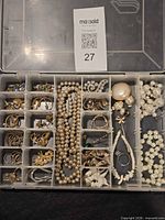 Overall view of tackle box showing all jewelry pieces in compartments