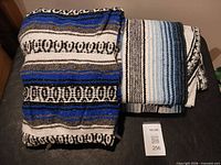 Two woven Mexican style blankets folded