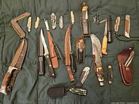 Full layout of knives, multi-tools, sheaths on quilt